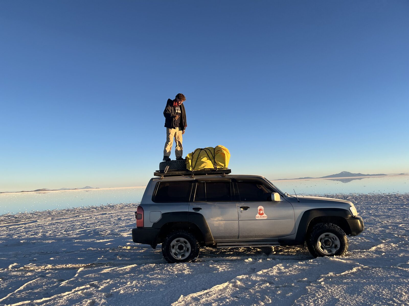 Benito standing on a vehicle in Bolivia’s Uyuni Salt Flats